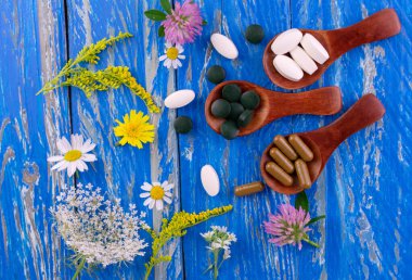 Homeopathic medicines and medicinal herbs. Flat lay.