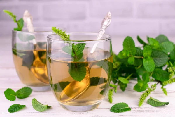 Mint tea in glasses on a white background.Close-up.