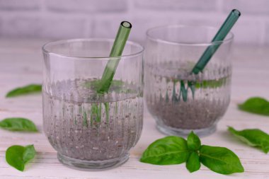 Two glasses of water with basil and chia seeds. Drink for weight loss.