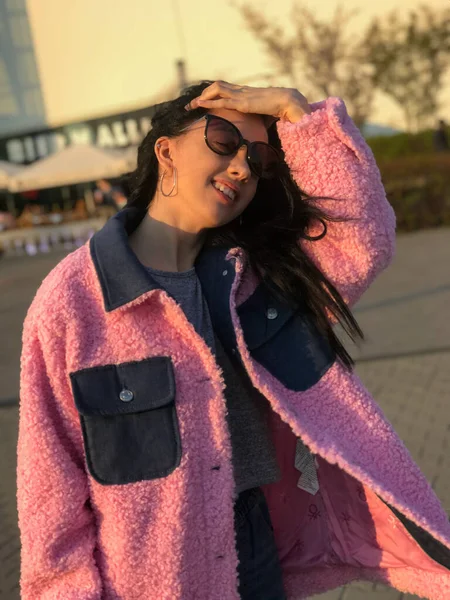 Pembe ceketli genç bayan, Polonya, Varşova 'daki ticaret merkezinin yanındaki altın saat sokakta vuruldu..