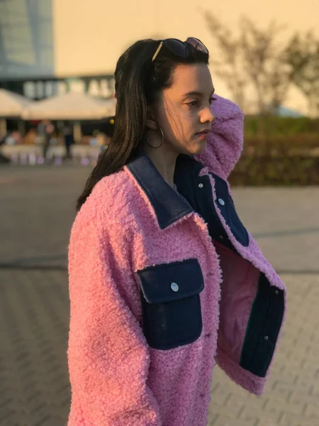 Pembe ceketli genç bayan, Polonya, Varşova 'daki ticaret merkezinin yanındaki altın saat sokakta vuruldu..