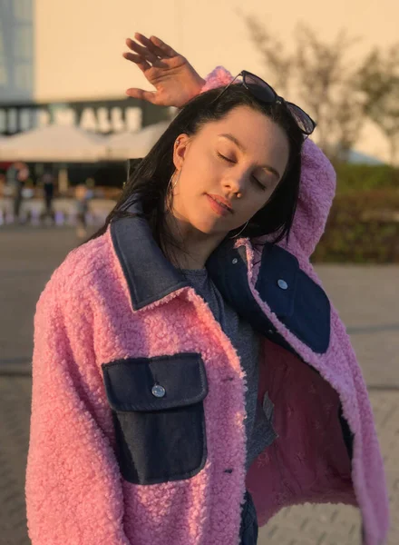 Pembe ceketli genç bayan, Polonya, Varşova 'daki ticaret merkezinin yanındaki altın saat sokakta vuruldu..