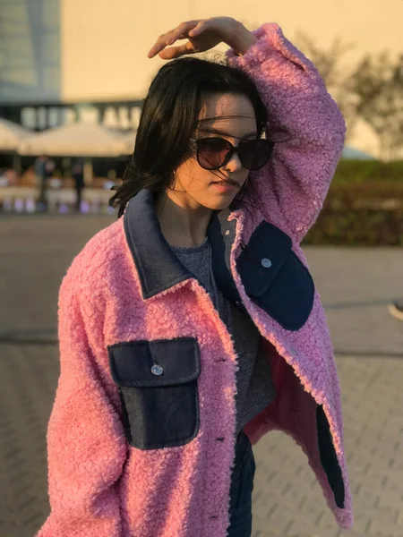 Pembe ceketli genç bayan, Polonya, Varşova 'daki ticaret merkezinin yanındaki altın saat sokakta vuruldu..