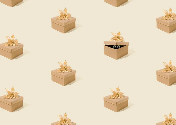Minimal abstract pattern with closed boxes and one open from which eyes protrude. Surprise Christmas, birthday, wedding or valentine gift concept. Funny texture on the pastel yellow background.