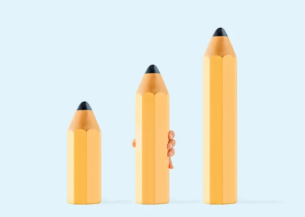 Yellow pencils lined up lengthwise. Child\'s hand holds pencil of medium length. Minimal abstract concept of middle level writing or drawing exercises. Pastel blue background. Back to school idea.