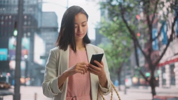 Japanerin nutzt Smartphone auf der Straße — Stockvideo