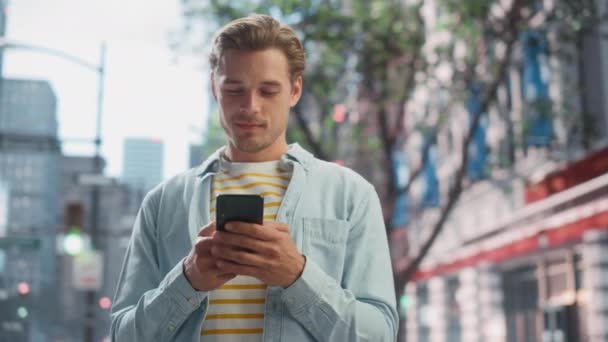 Handsome Man Uses Smartphone on City Street — Stock Video