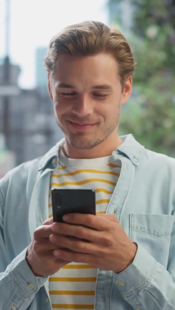 Vertical Portrait Handsome Man Uses Smartphone on City Street — Stock video