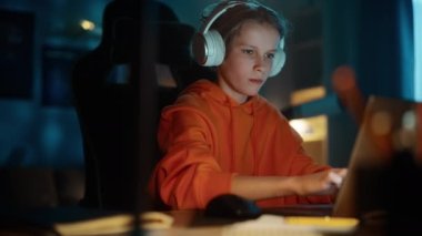 Kulaklıklı Genç Evde Dizüstü bilgisayar kullanıyor