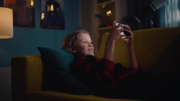 Young Boy Playing Game on Smartphone at Home — Stock Video