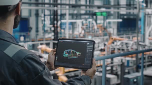 Manlig ingenjör med bärbar dator med CAD-ritning på bilfabriken — Stockvideo