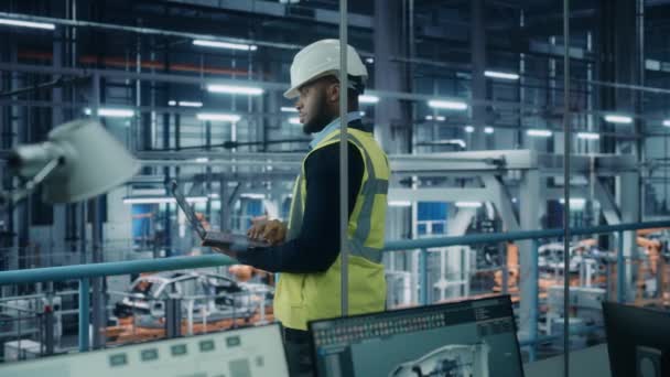 自動車工場でタブレットコンピュータを使用する男性エンジニア — ストック動画
