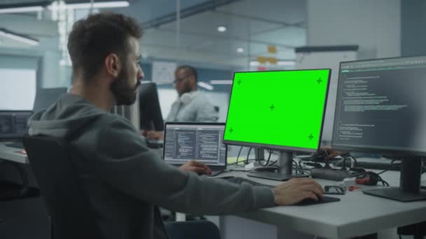 Programmeur utilisant l'économiseur d'écran vert dans le bureau — Video