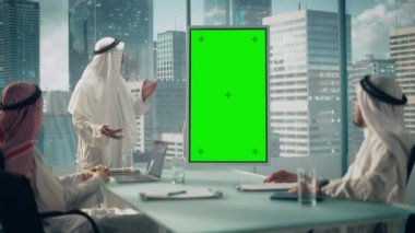 Saudi Emirati Arab Business Manager Giving Presentation on Green Screen Monitor