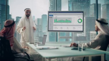 Saudi Emirati Arab Business Manager Giving Presentation in Office