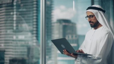 Saudi Emirati Arab Businessman Using Laptop