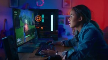 Woman Playing 3D Shooter on PC at Home