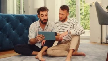 Two Men Using Tablet at Home