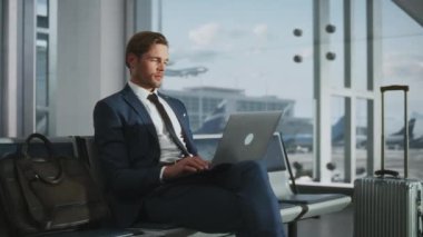 İşadamı laptopta çalışıyor. Havaalanında bekliyor.