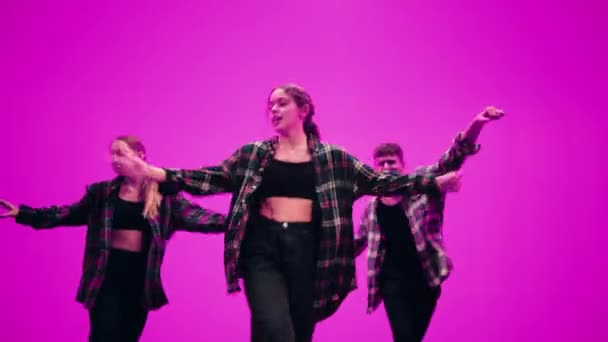 Three Dancers Performing in Front of Animated Digital Screen — Stock Video