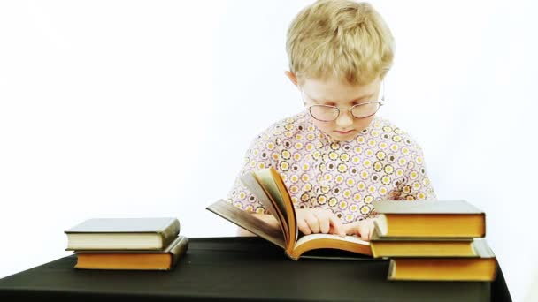 Маленький хлопчик читає книги — стокове відео