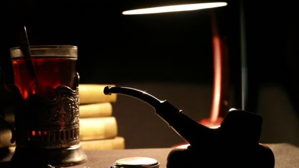 Old military NKVD Cabinet still life with smoking pipe, glass of tea and desktop lamp — Stock Video