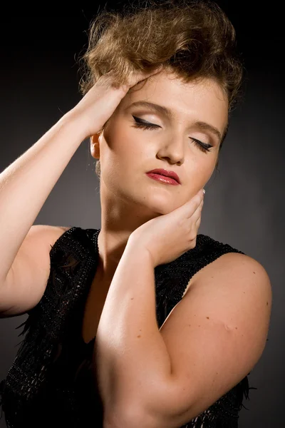 Girl with closed eyes in a black dress — Stock Photo, Image