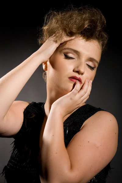 Girl with closed eyes in a black dress — Stock Photo, Image