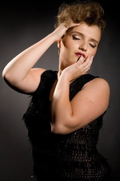 Girl with closed eyes in a black dress — Stock Photo, Image