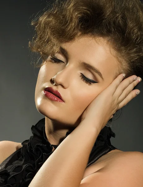 Girl with closed eyes in a black dress — Stock Photo, Image