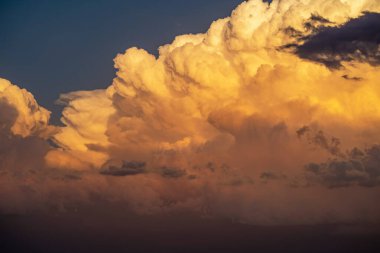 Thunderhead clouds form during the summer evening