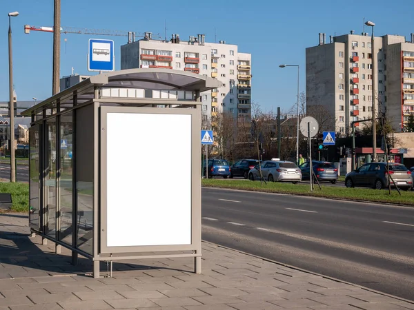 Empty blank white cut out bus stop advertisement poster, vertical ad banner sign board, city advert on the street, urban public space advertising placeholder simple template, daytime, nobody