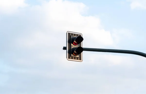 Single set of double traffic lights, object isolated on light blue sky background, copy space. Traffic management symbol, city street, transportation, public transport organization, nobody, no people