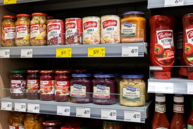 Krakow, Poland, food products, necessities, Zabka store shelves detail shot, group of objects on a shelf, price tags closeup, no people. Food retail business concept