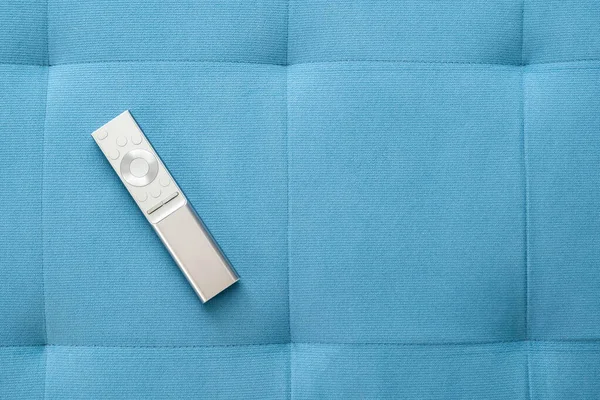 One Single Simple Sliver Smart Remote Control Laying Blue Sofa — Zdjęcie stockowe