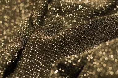 Parlak ışıl ışıl lurex kumaş dokusu. Altın rengi..