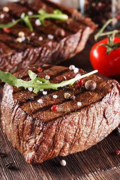 Close up of two juicy thick portions of delicious roasted or grilled beef steak — Stock Photo, Image