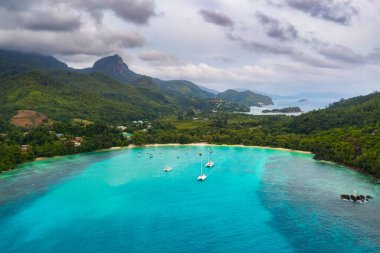 Aerial view of Mahe island with yachts, mountains and Indian Ocean in Seychelles clipart