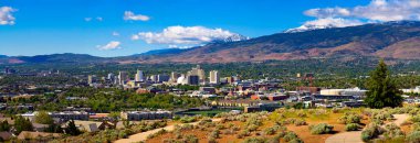 Downtown Reno skyline, Nevada, with hotels, casinos and the surrounding High Eastern Sierra foothills