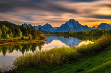Colorful sunset over Oxbow Bend of the Snake River and Mount Moran in Grand Teton National Park, Wyoming, USA. Long exposure.
