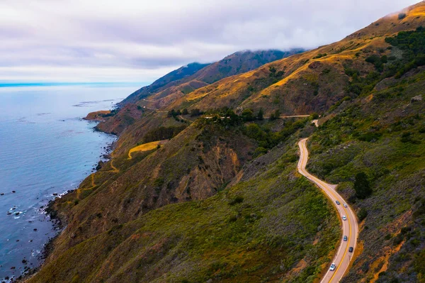 Aerial view of the Pacific Coast Highway going along the coastline in California, USA.