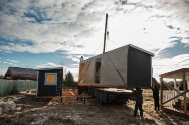 Modüler çerçeveli bir evin teslimatı ve kurulumu. Küçük evlerin iskeleti. Modüler konut inşaatı. Senin evin. Ucuz bir ev..