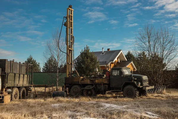 The drilling rig is drilling a well for water. Water extraction on a private plot of land.