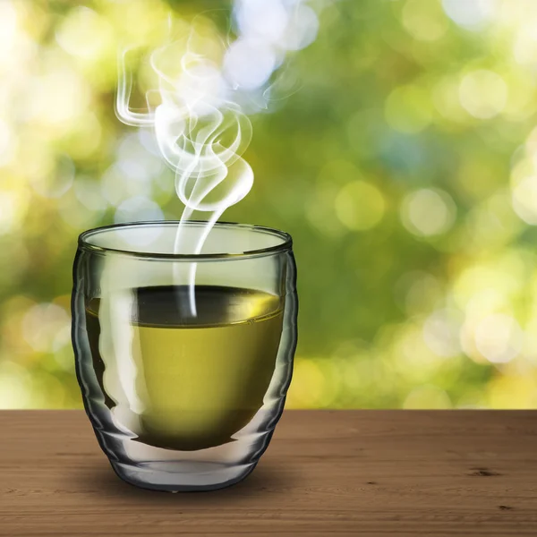 Hot green tea on wood table with outdoor background — Stock Photo, Image