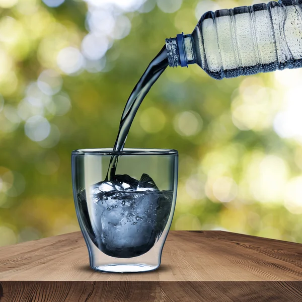 Water Bottle pour the water into the glass Stock Photo by ©somchaij