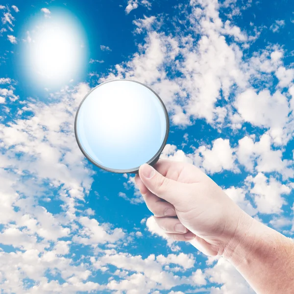 Man holding magnifying glass — Stock Photo, Image