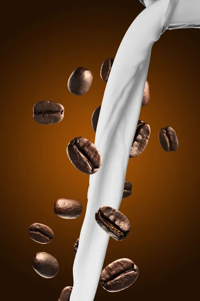 Milk pour onto coffee beans — Stock Photo, Image