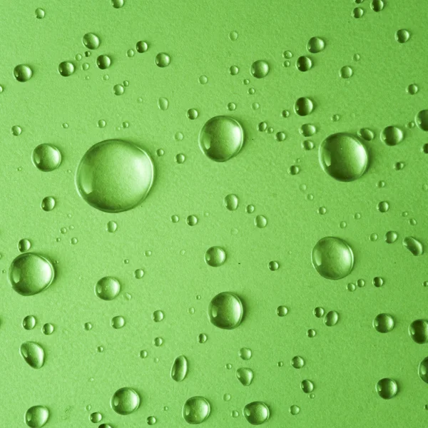 Water drops on green background — Stock Photo, Image