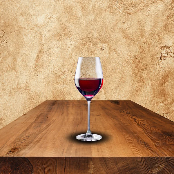 Glass of red wine on wood table — Stock Photo, Image