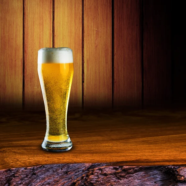Glass of beer on wood table — Stock Photo, Image
